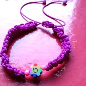 A purple smiley face bracelet